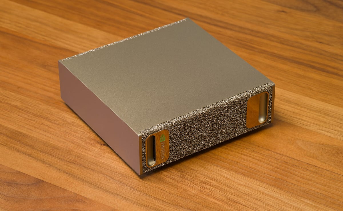 NVIDIA DGX Spark, a small champagne-gold desktop AI computer with a textured metal-foam front panel, shown at an angle.